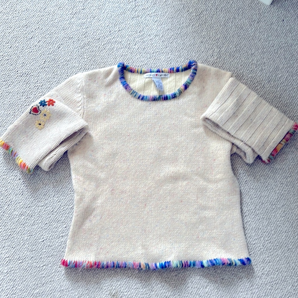 Tan sweater with flecks of color throughout.